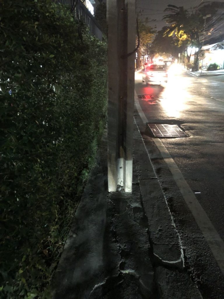 thailand sidewalk with a pole in a middle at night